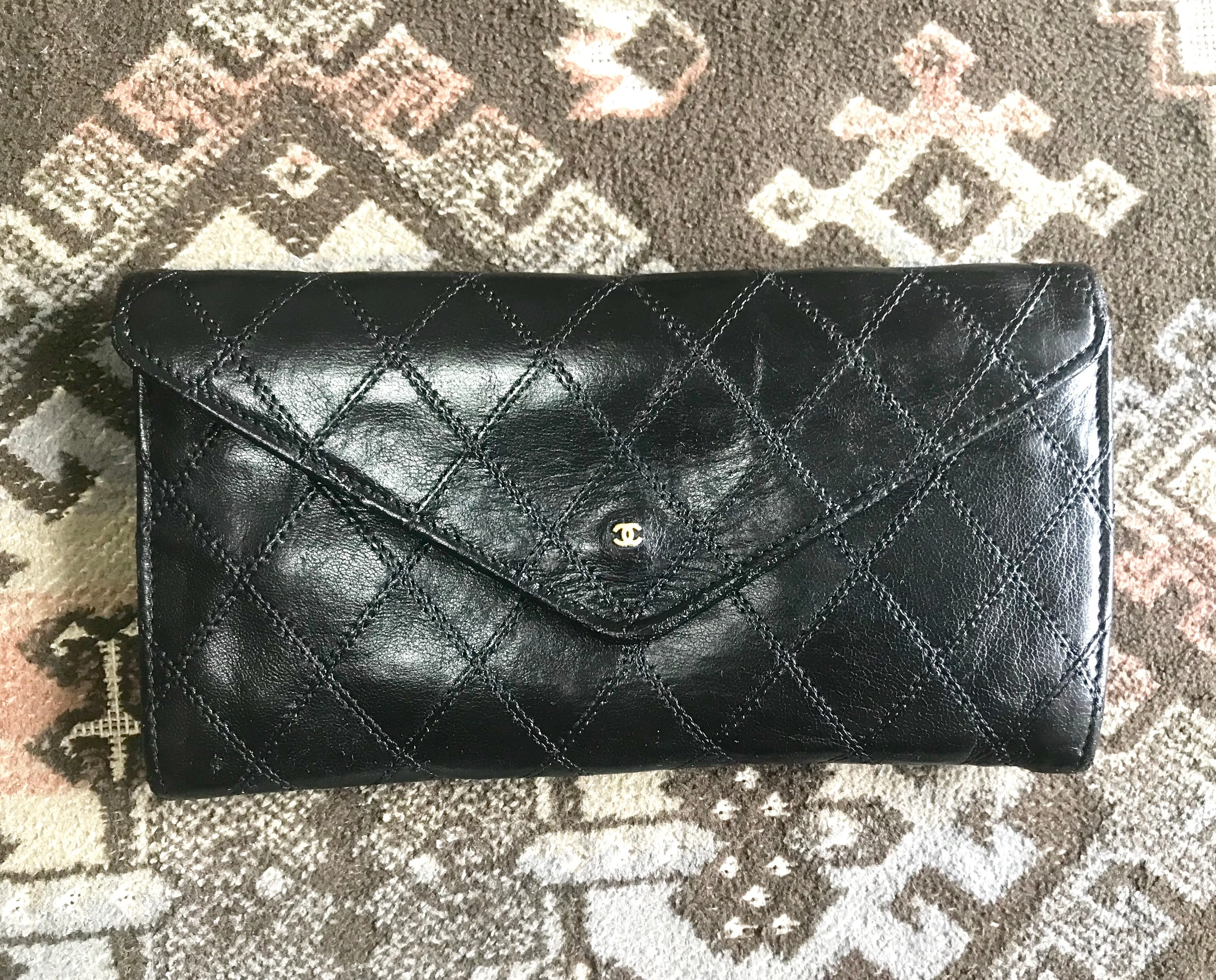 1980s. Vintage CHANEL black goatskin bill, card, checkbook long wallet pouch purse with  mini CC motif.  Classic unisex style.